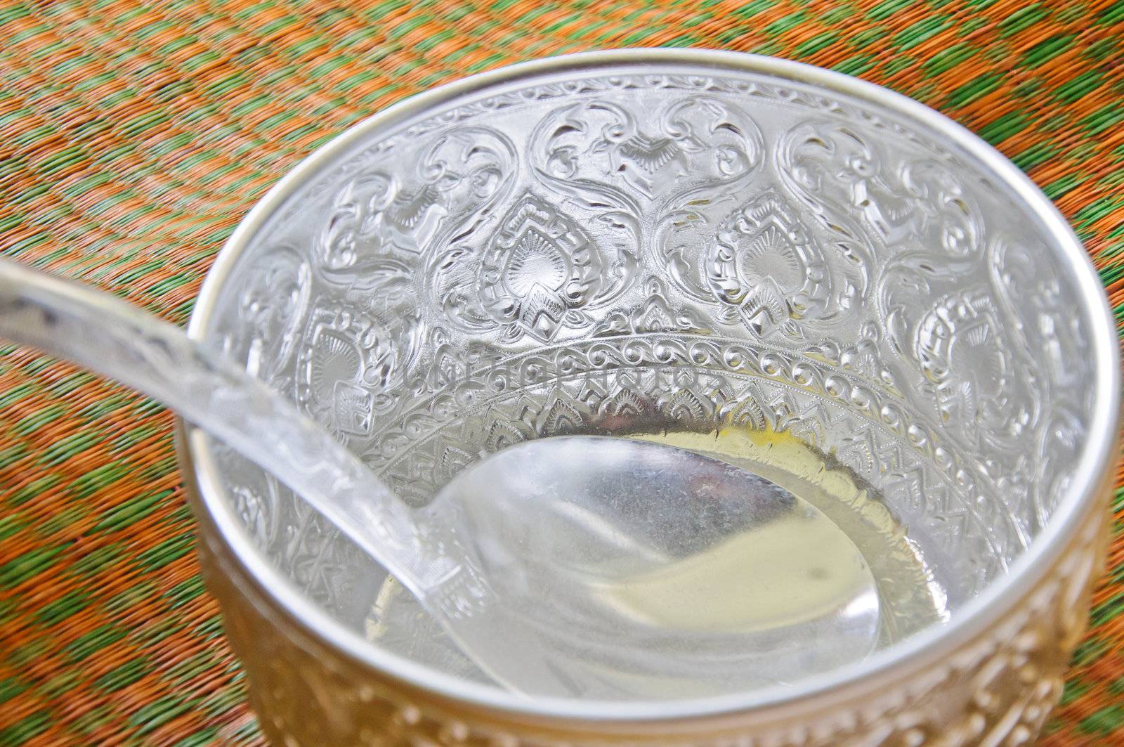 Water bowl made ​​of silver in Thailand style on the mat