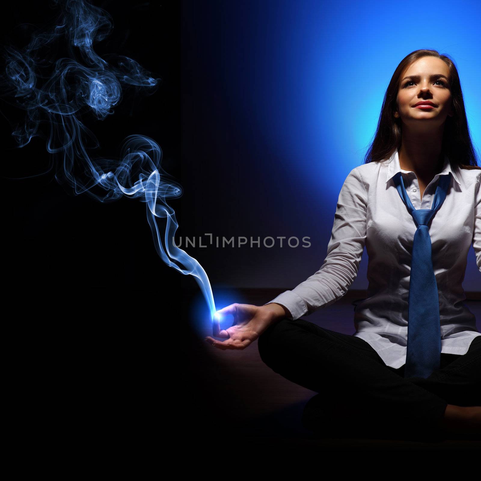 Young business woman sitting in asana lotus and meditating