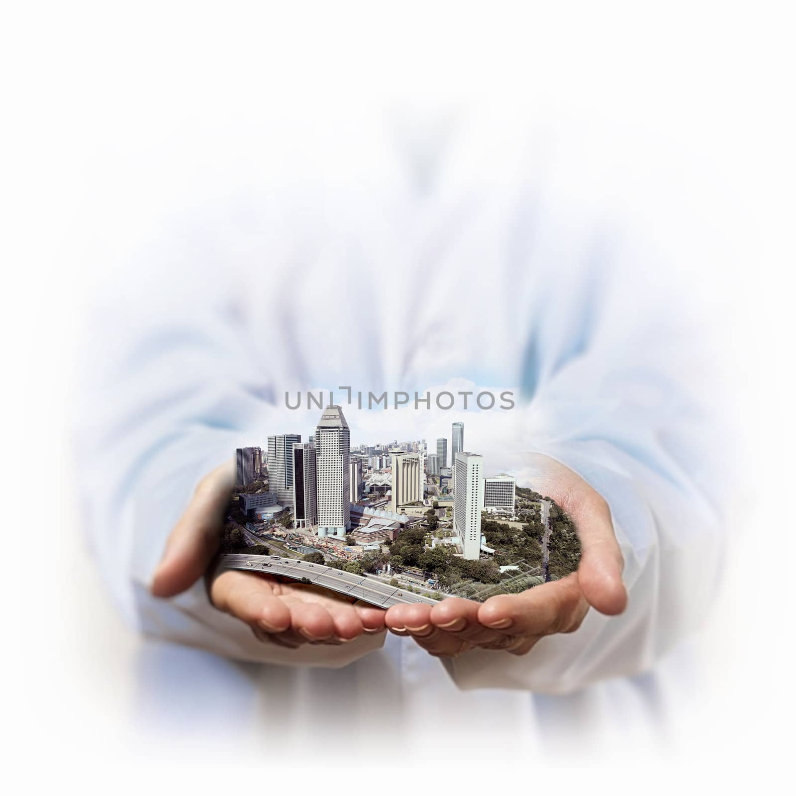 Image of a modern cityscape in the hand of a businessman