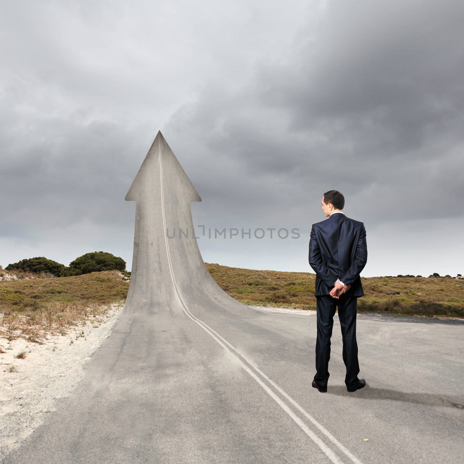 Concept of the road to success with a businessman standing on the road