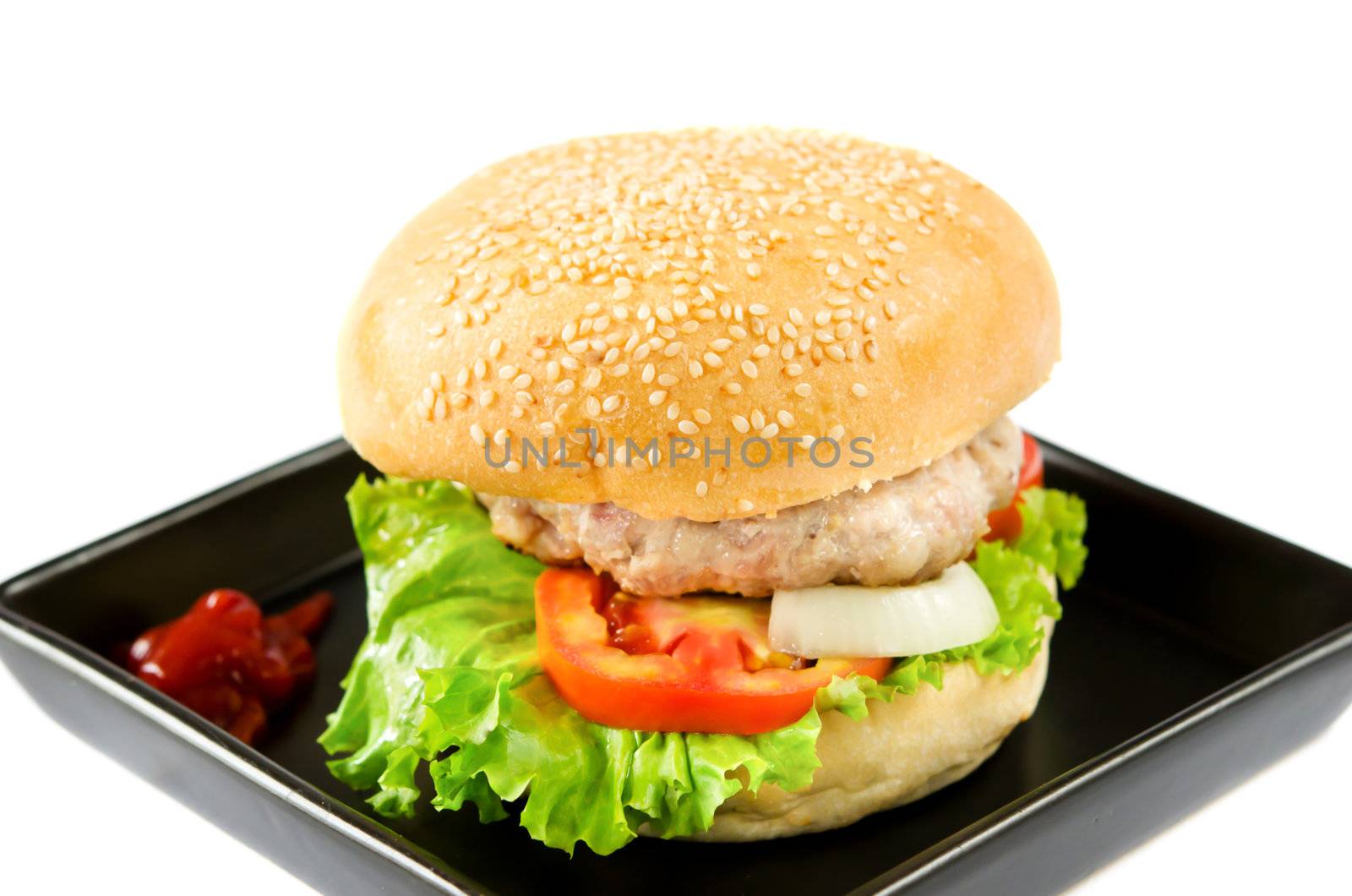 hamburger with tomato sauce on black dish