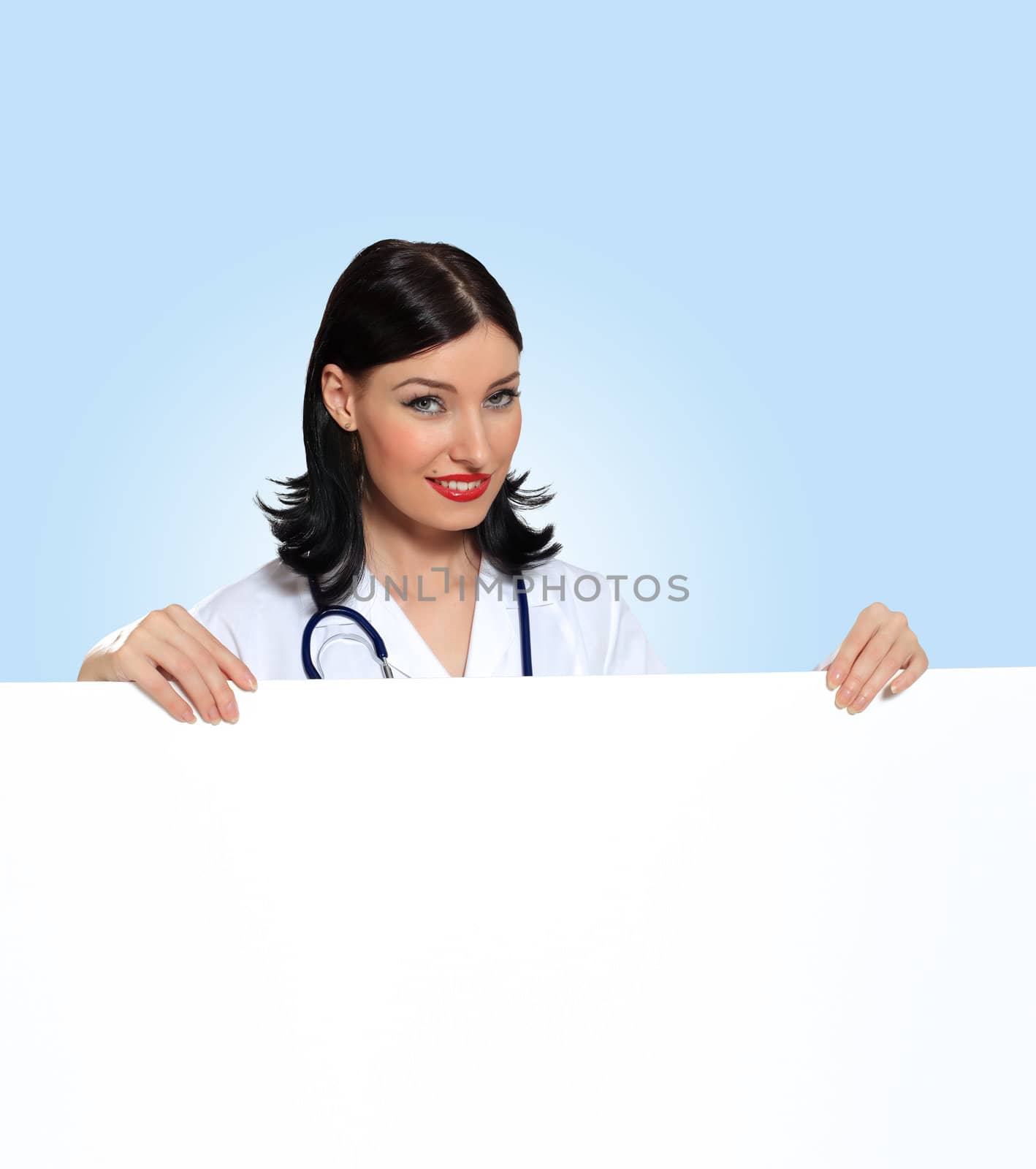 Portrait of happy successful young female doctor holding blank banner