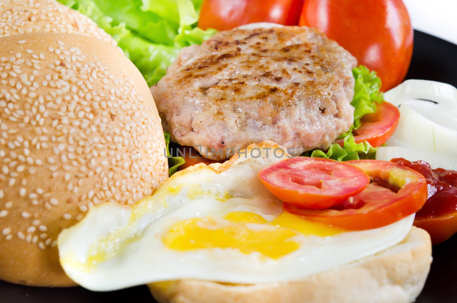 full breakfast with fried eggs, fresh vegetable , bread and fried pork