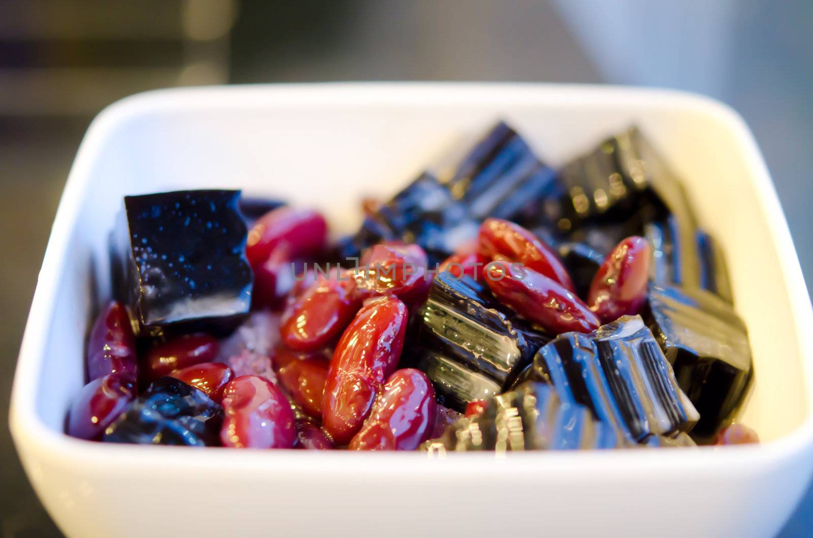 asian dessert, a kind of Chinese vegetable jelly black in color and red bean