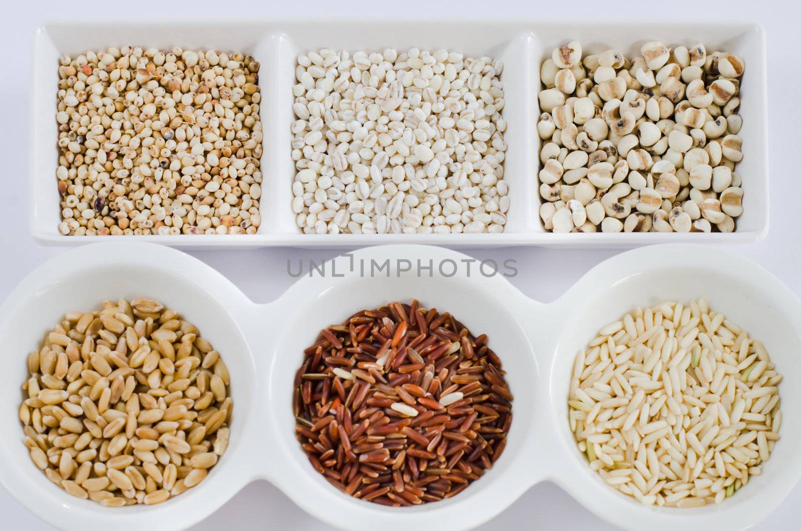  rice , red rice , wheat,  job's tears , barley and millet grains on white bowl