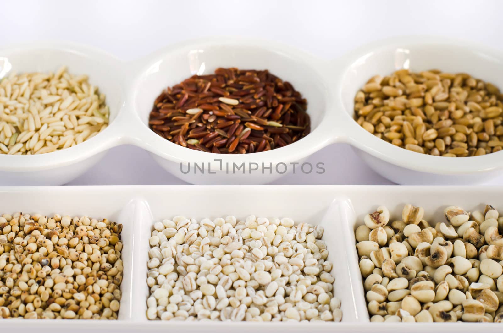 Grain and Cereal Set ,  rice , red rice , wheat,  job's tears , barley and millet grains on white bowl
