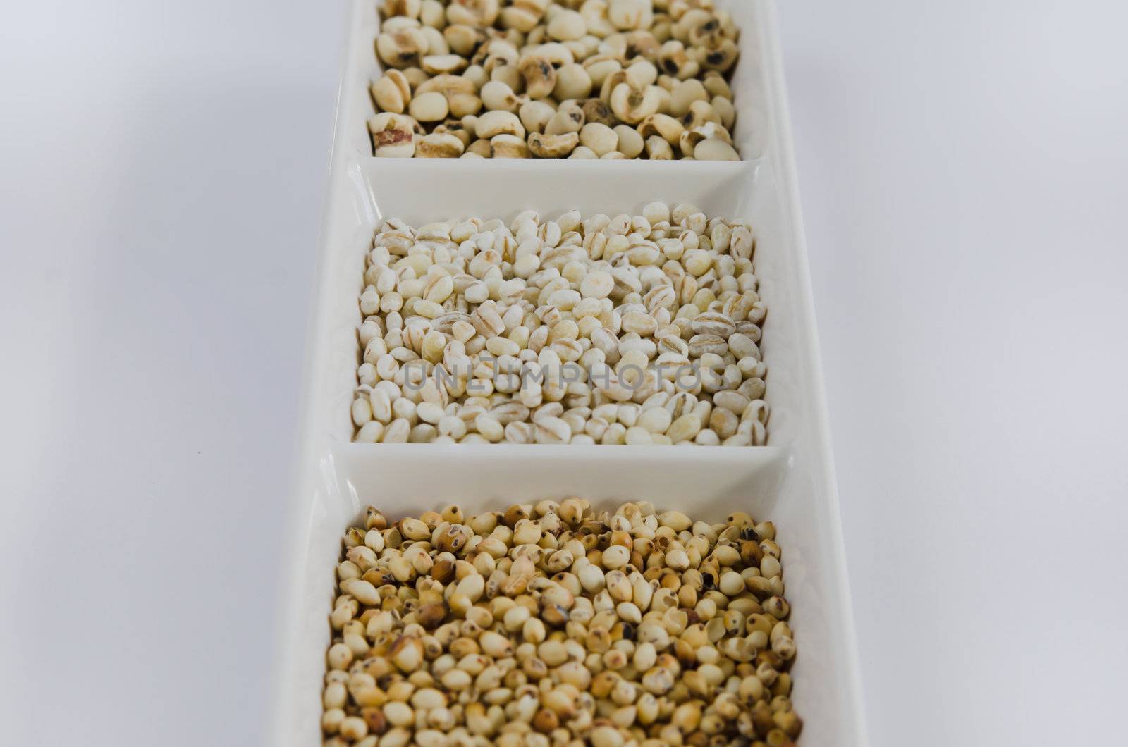 Cereals collection , job's tears , barley and millet grains on white bowl