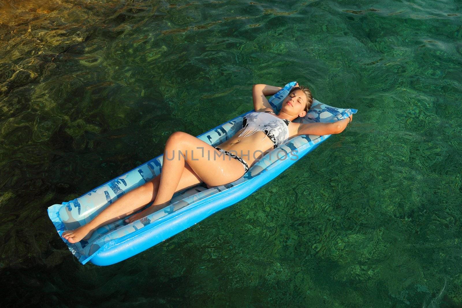 Young woman floating on the sea