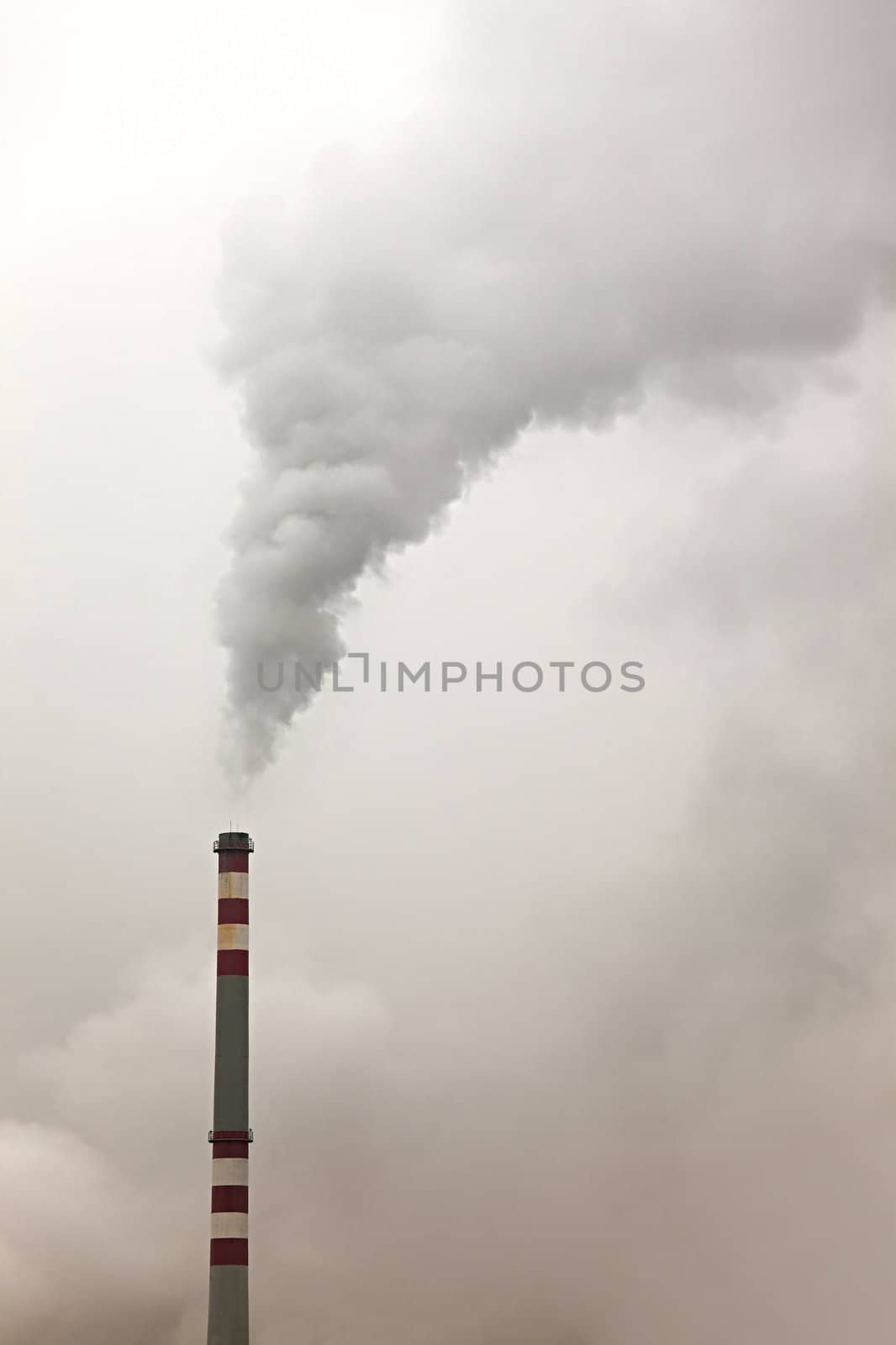 Thick smoke rising from an industrial chimney