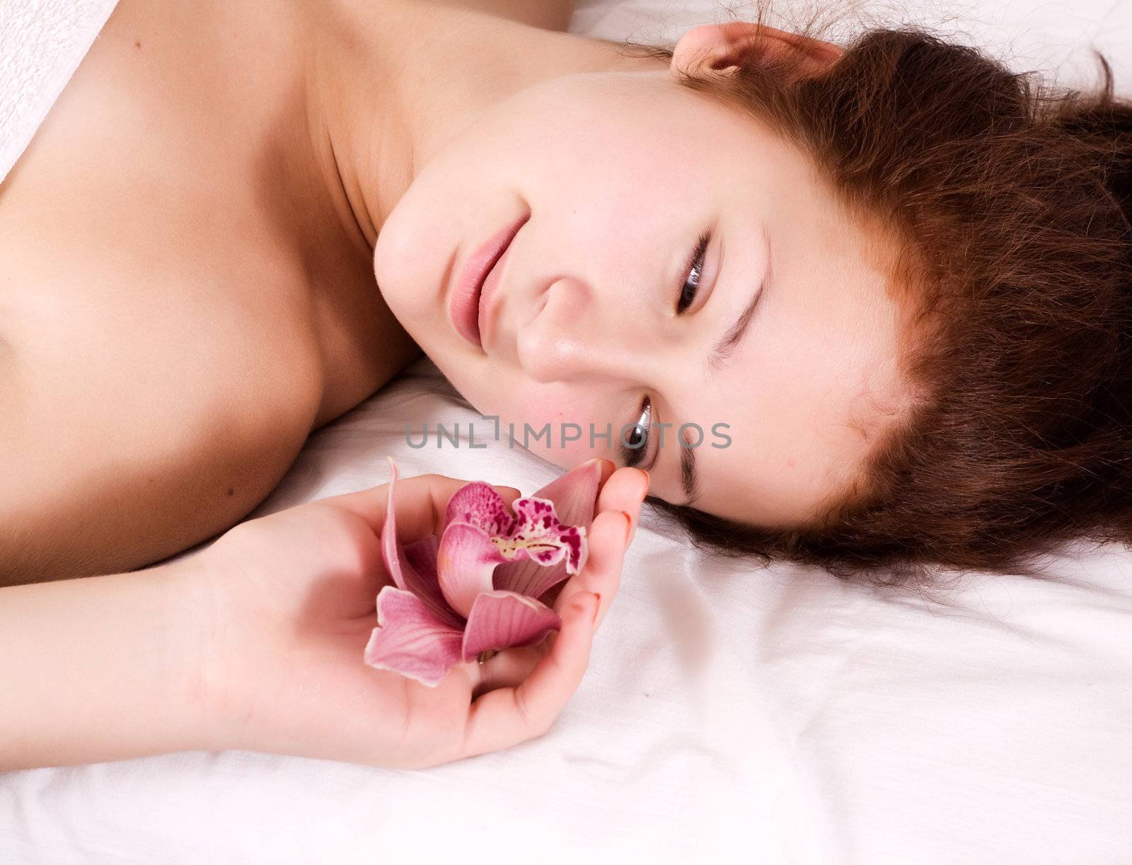 Beautiful young naked woman isolated on white background.
