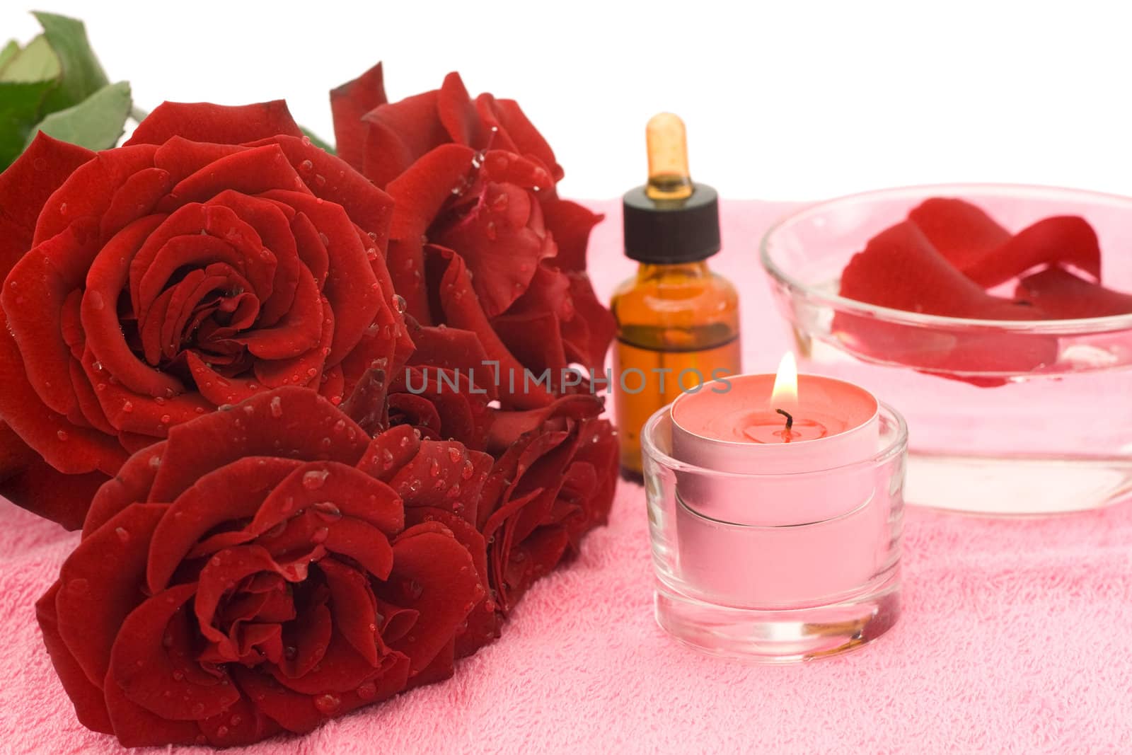 Essential oil and rose petals isolated