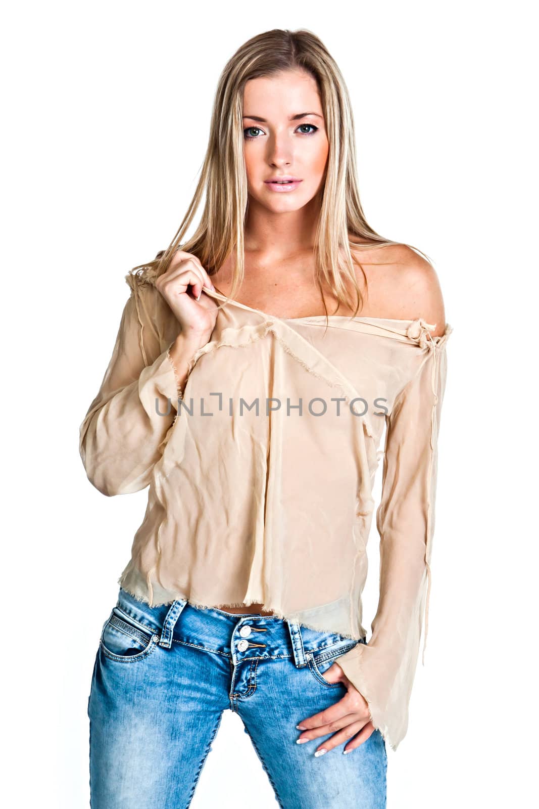 Young and beautiful woman in a beige blouse and blue jeans