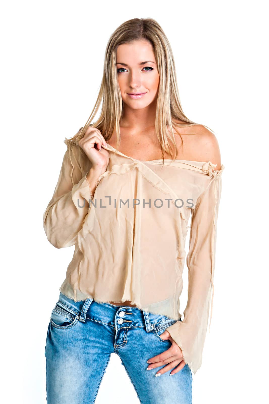 Young and beautiful woman in a beige blouse and blue jeans