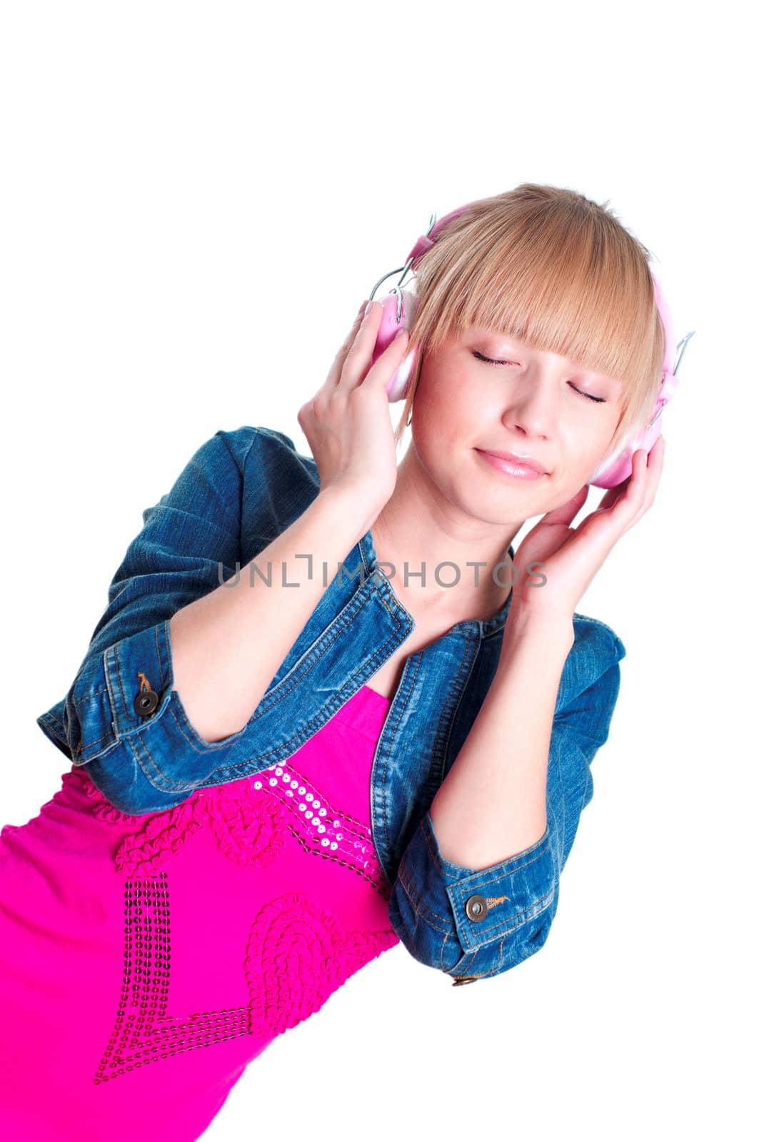 Young attractive woman listing to music with headphones against white background