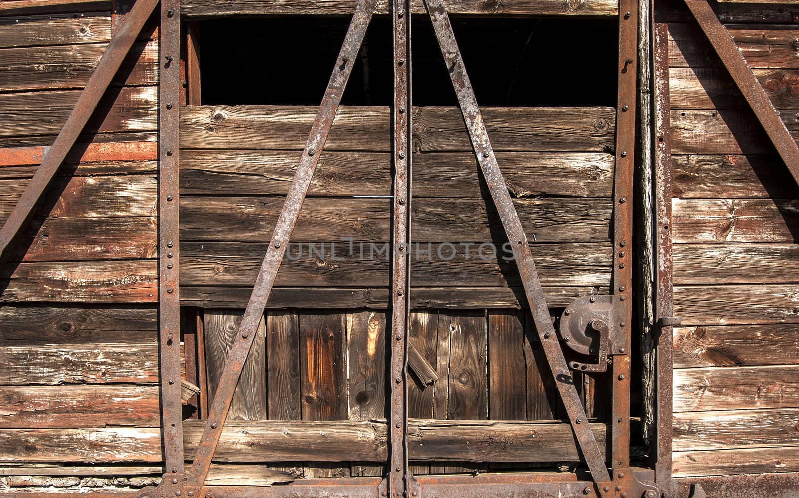 Old railway brown wooden wagon side door as background
