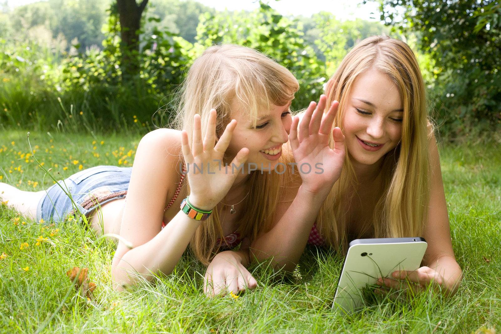Girls waving with a tablet by DNFStyle