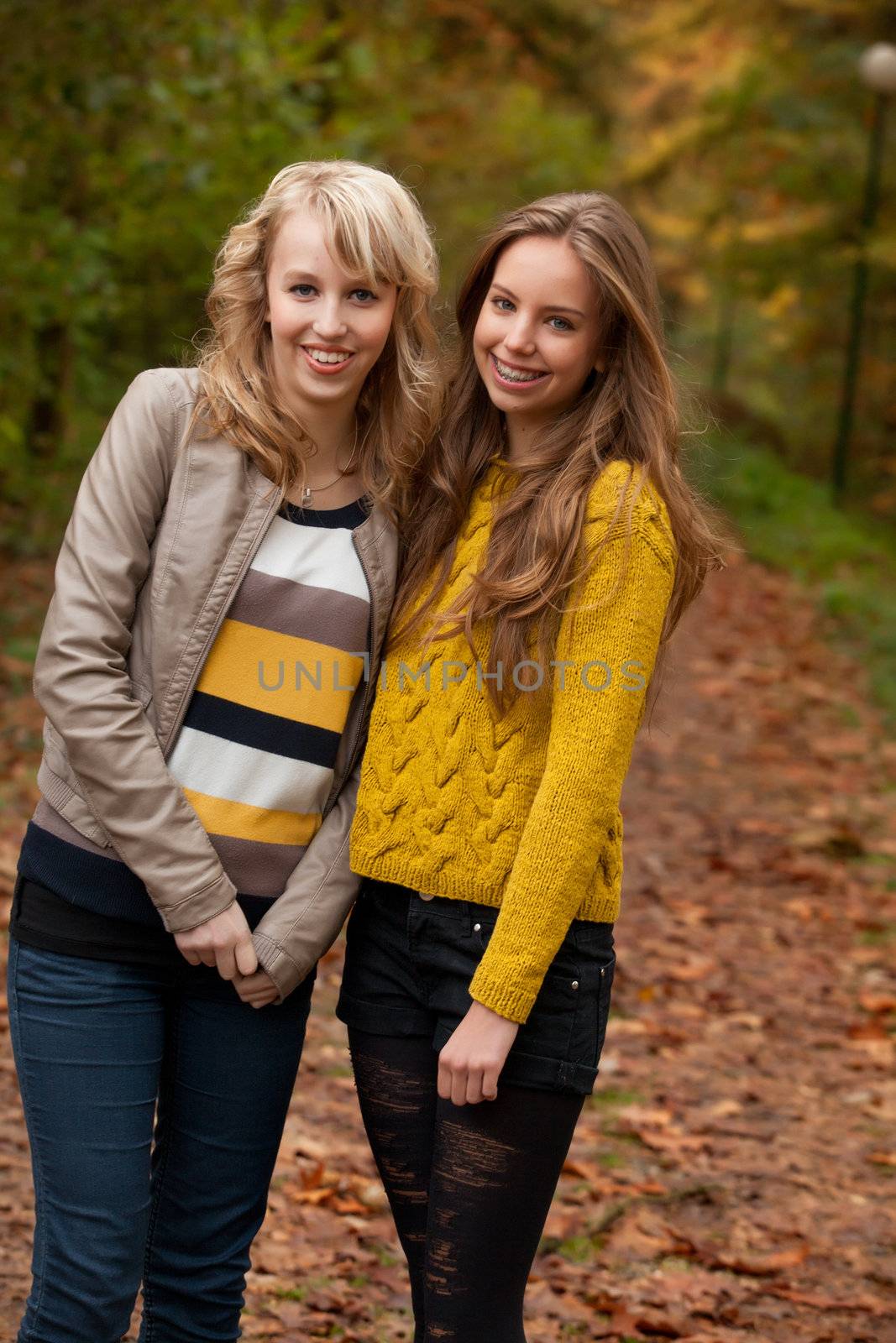 2 girls are having fun in the forest