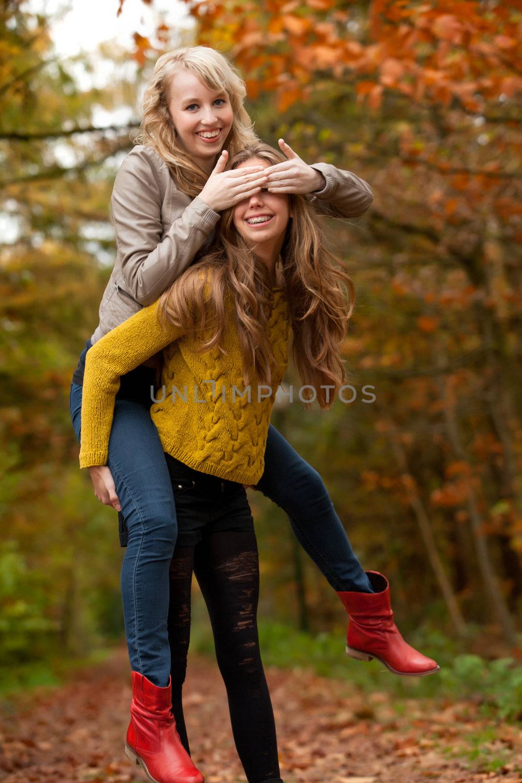 2 girls are having fun in the forest