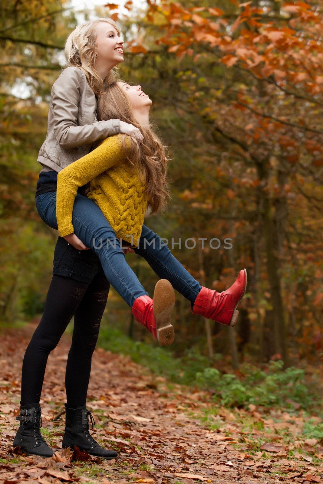 2 girls are having fun in the forest