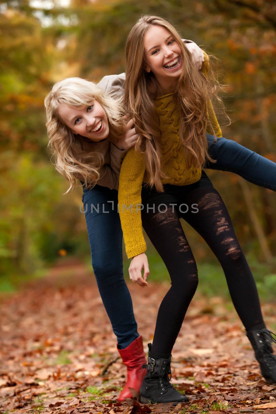 2 girls are having fun in the forest