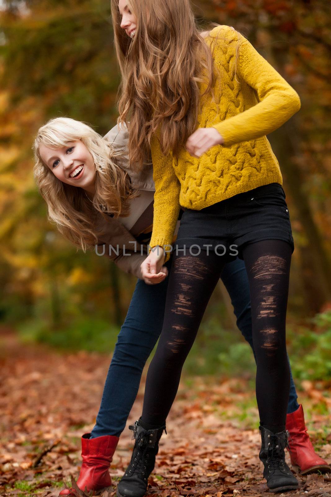 2 girls are having fun in the forest