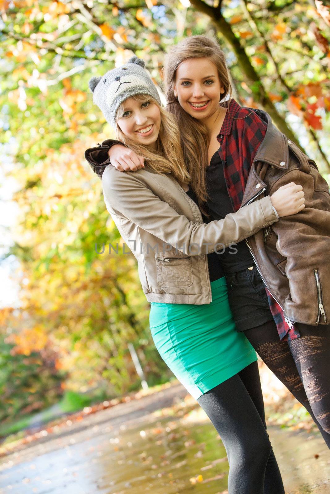 2 girls are having fun in the forest