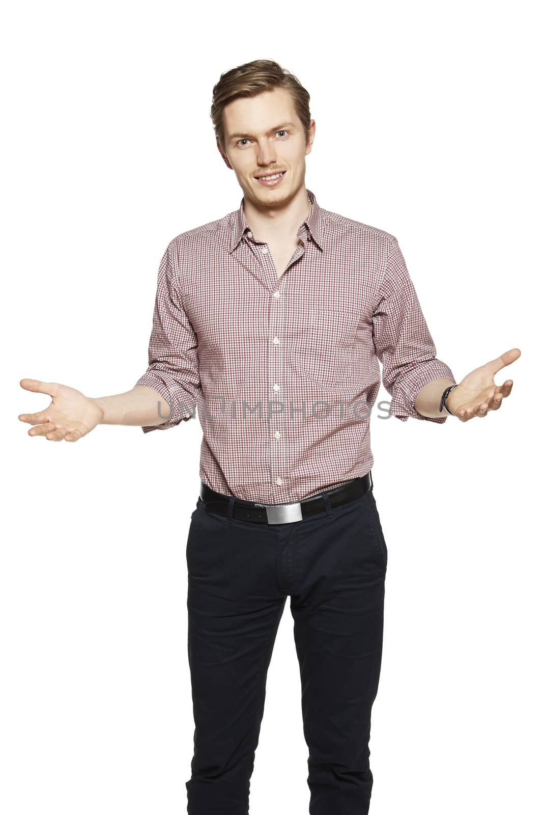 Young man throws up his hands. Studio shot of young man against a white background.