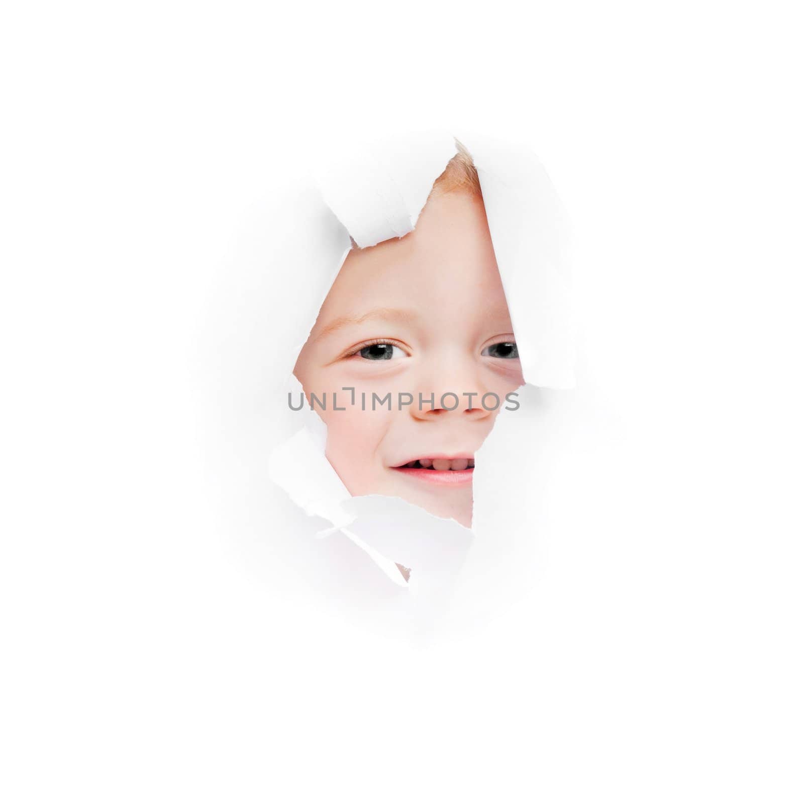 child looks in a hole in a sheet of a paper