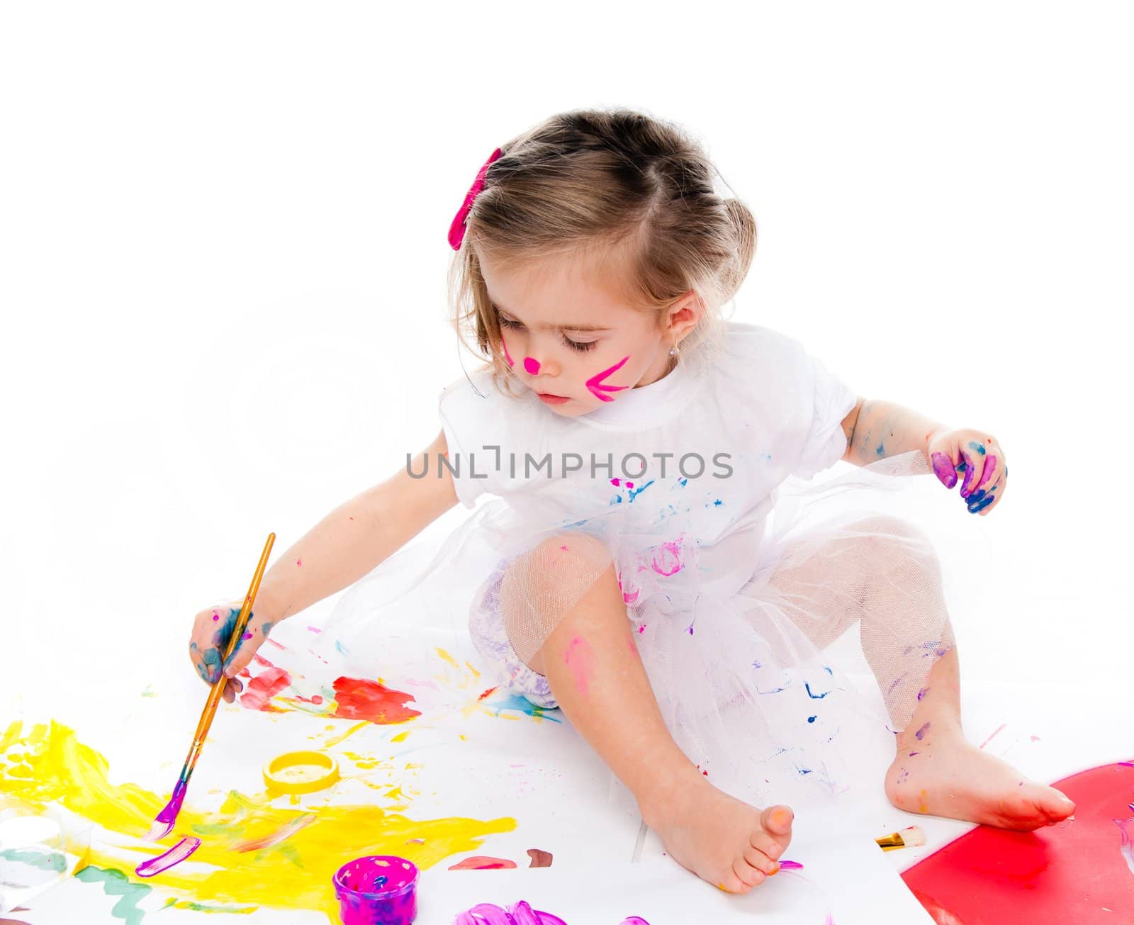 little girl with a brush and paints