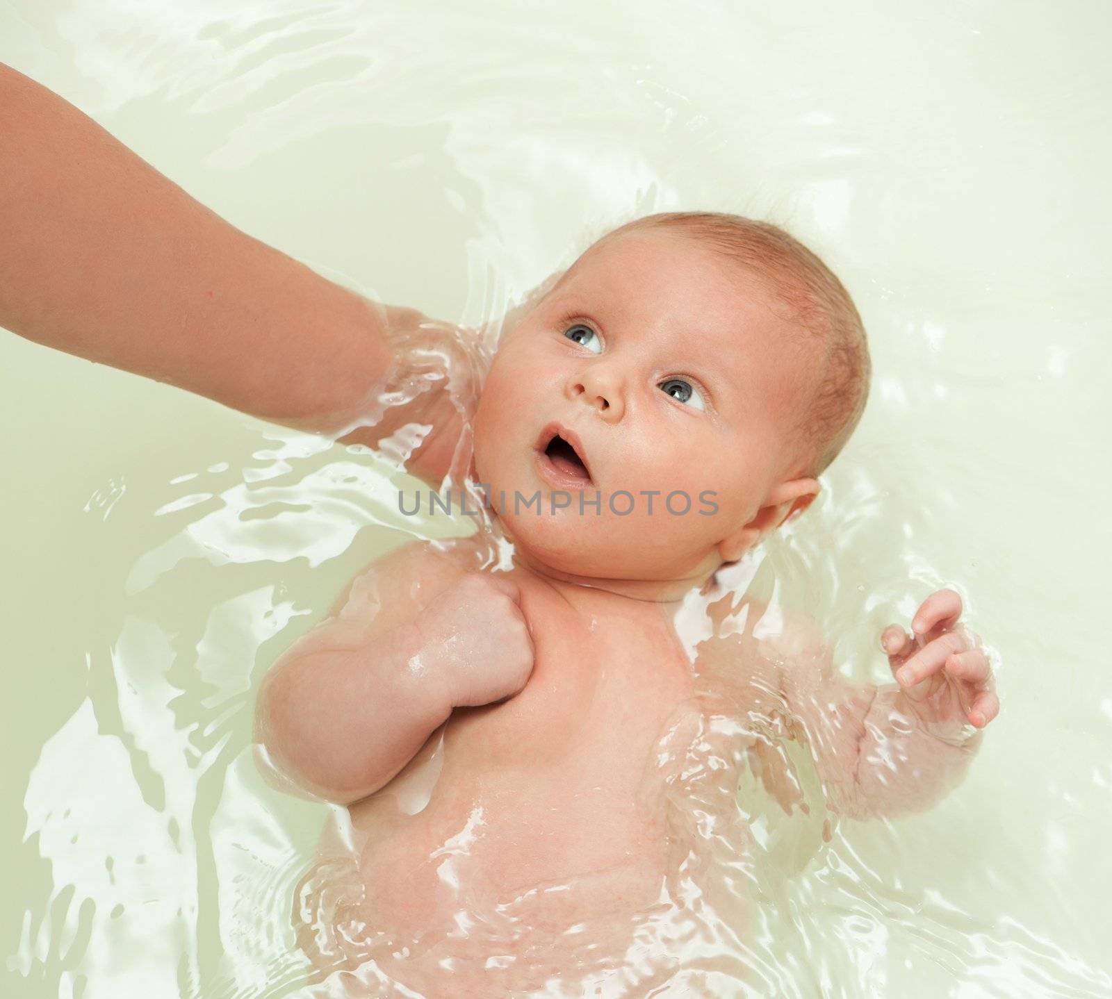 Baby swimming in the blue water