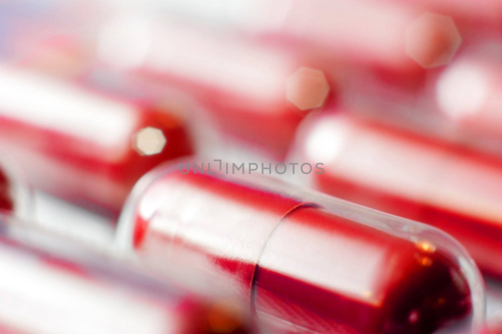 Macro of red capsules on blur background