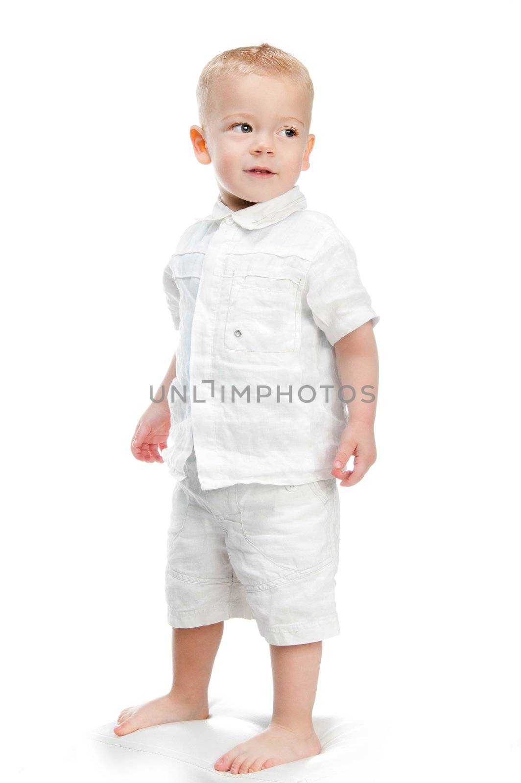 Portrait of a happy little boy standing isolated over white background