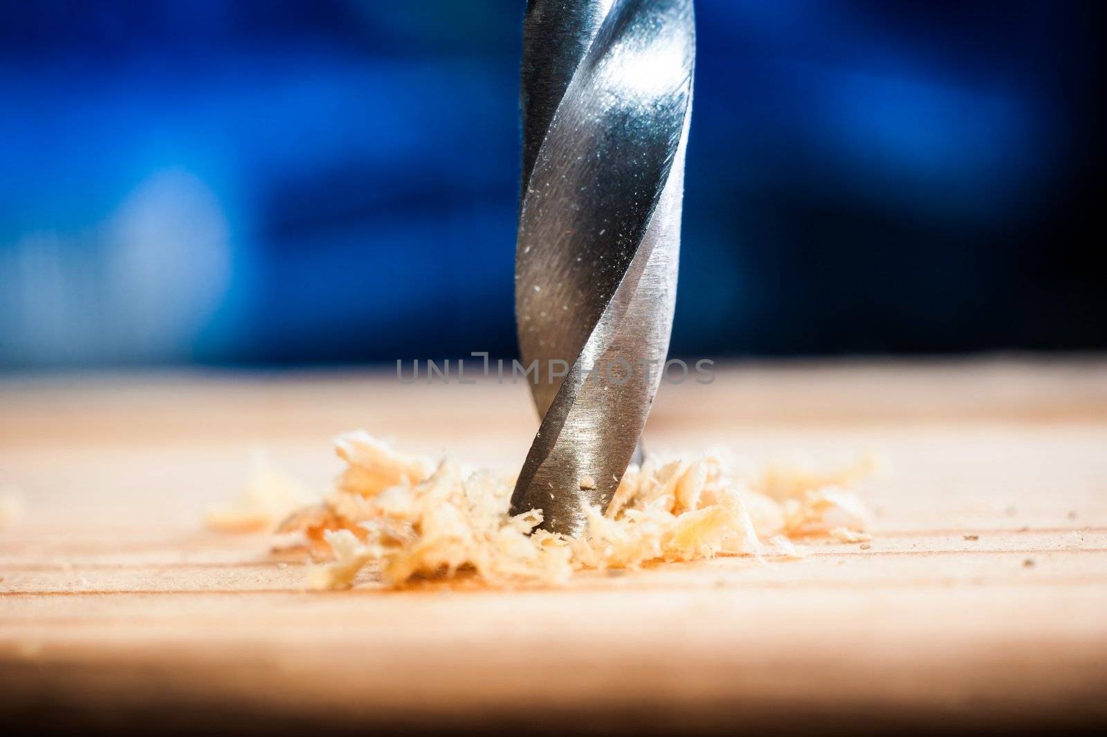 power drill bit closeup with wood