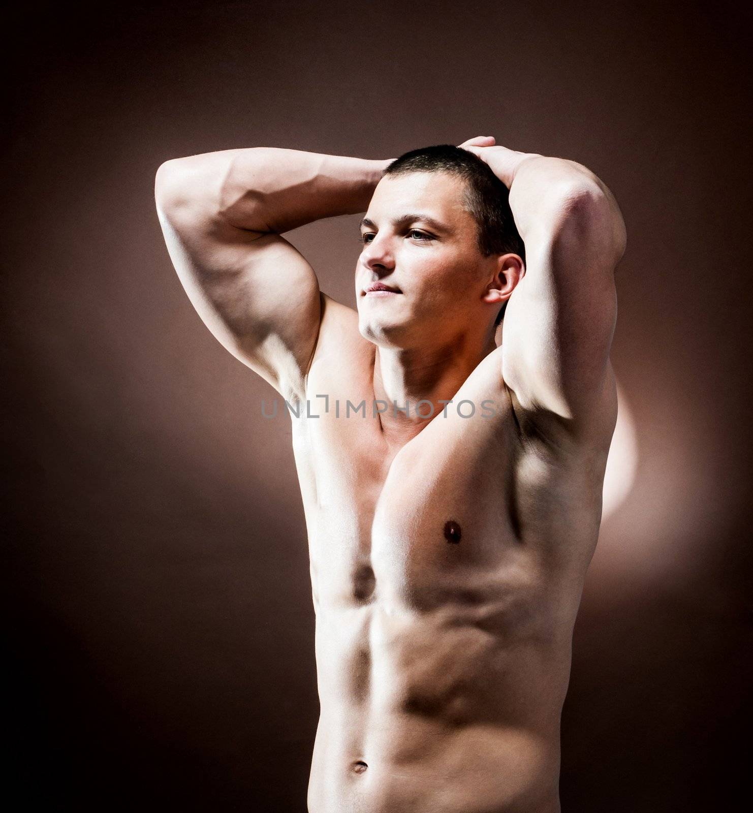 strong athletic man on brown background