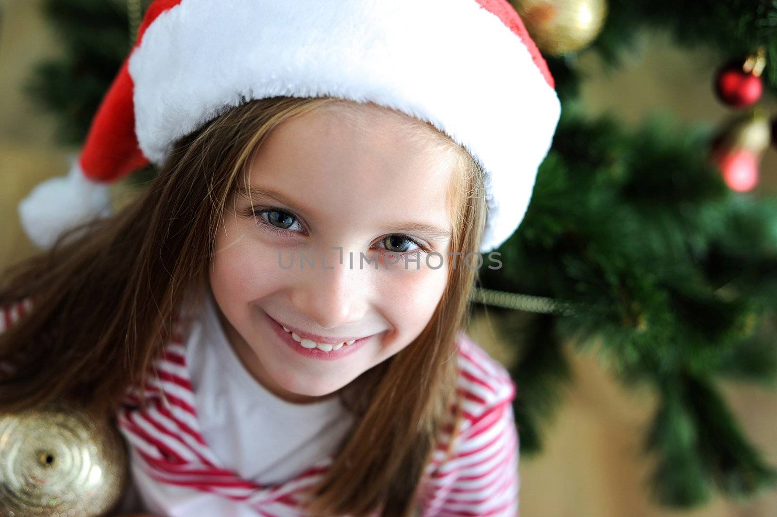 portrait of adorable happy christmas child in santa hat closeup