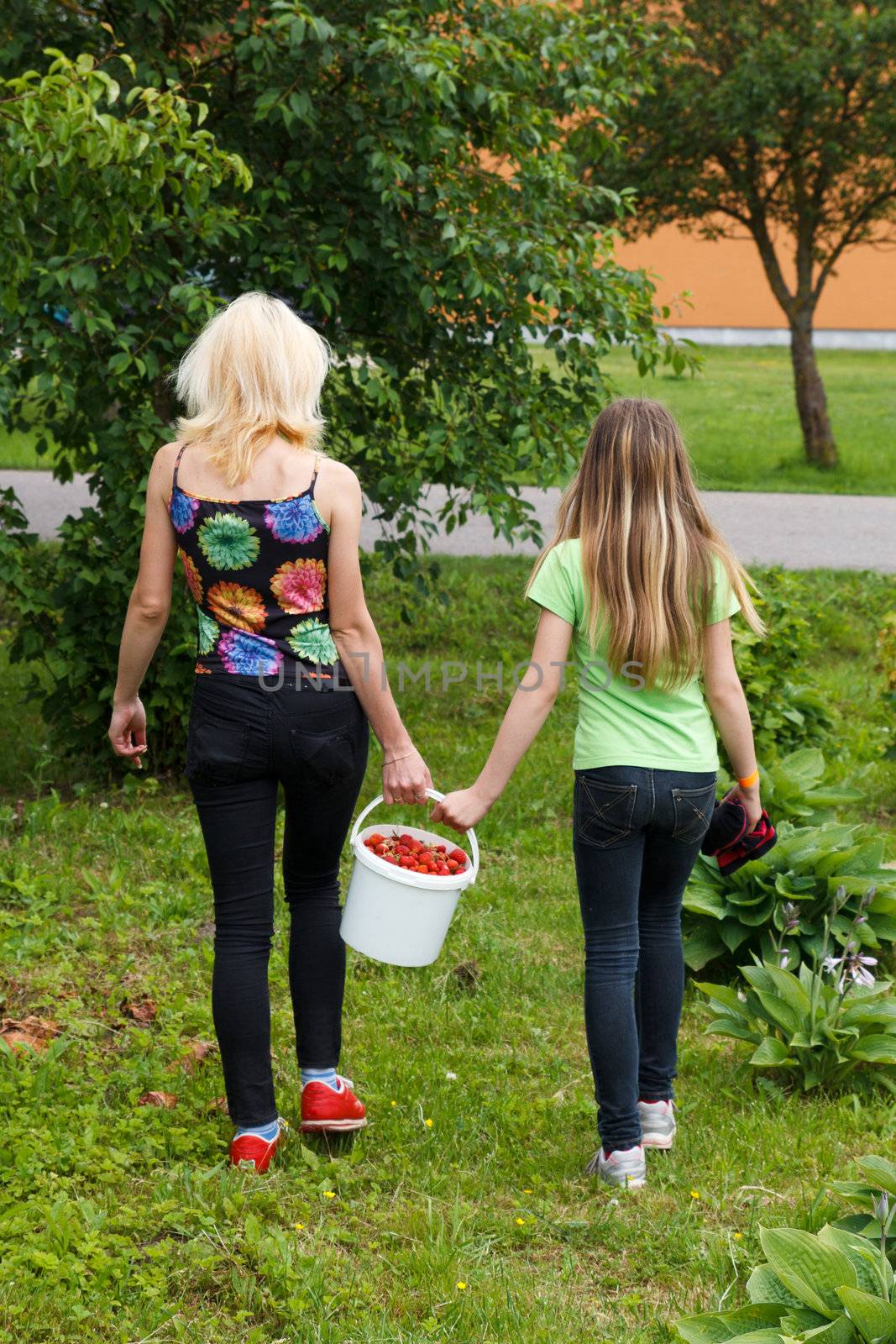 Mother and daughter walk home from the garden by AigarsR
