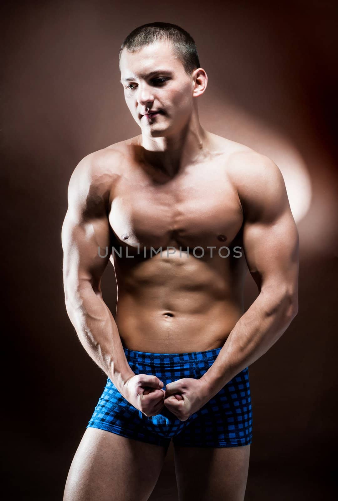 strong athletic man on a brown background