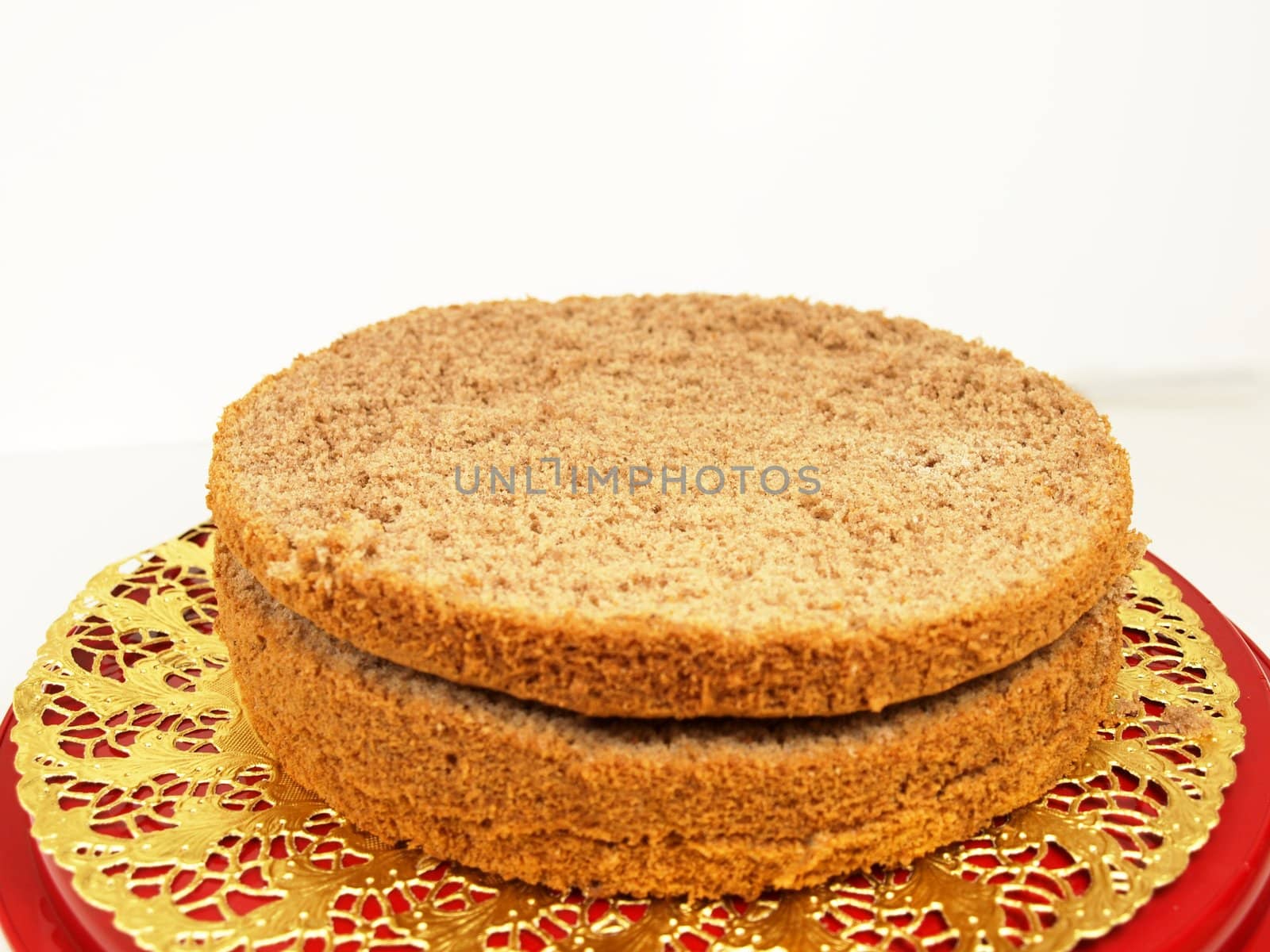 Chocolate layer cake, in slices, isolated on a golden paper by Arvebettum