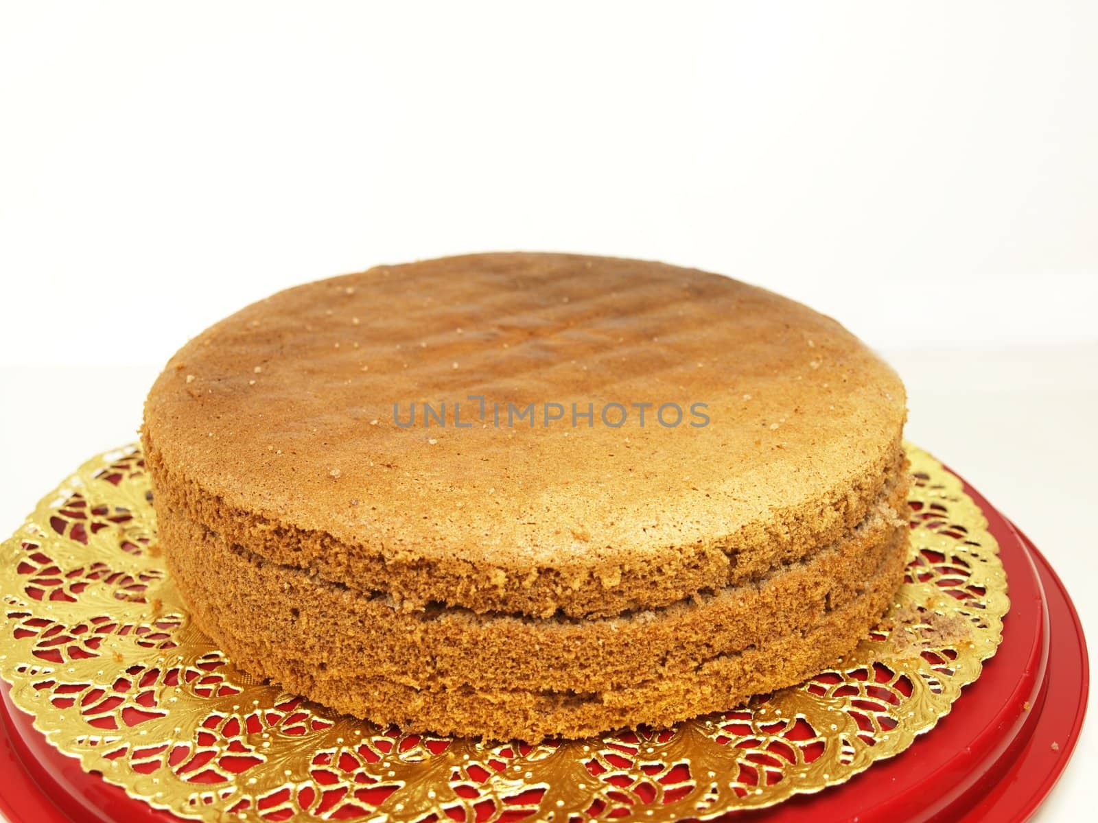 Chocolate layer cake, in slices, isolated on a golden paper by Arvebettum