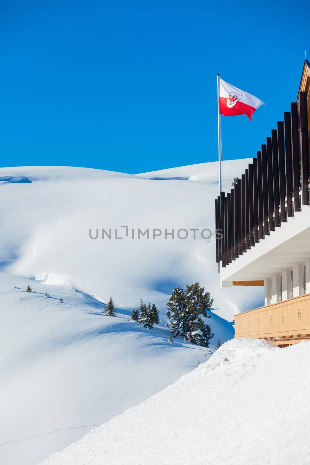 Waving Austrian flag aganst blue sky in Austrian Alps
