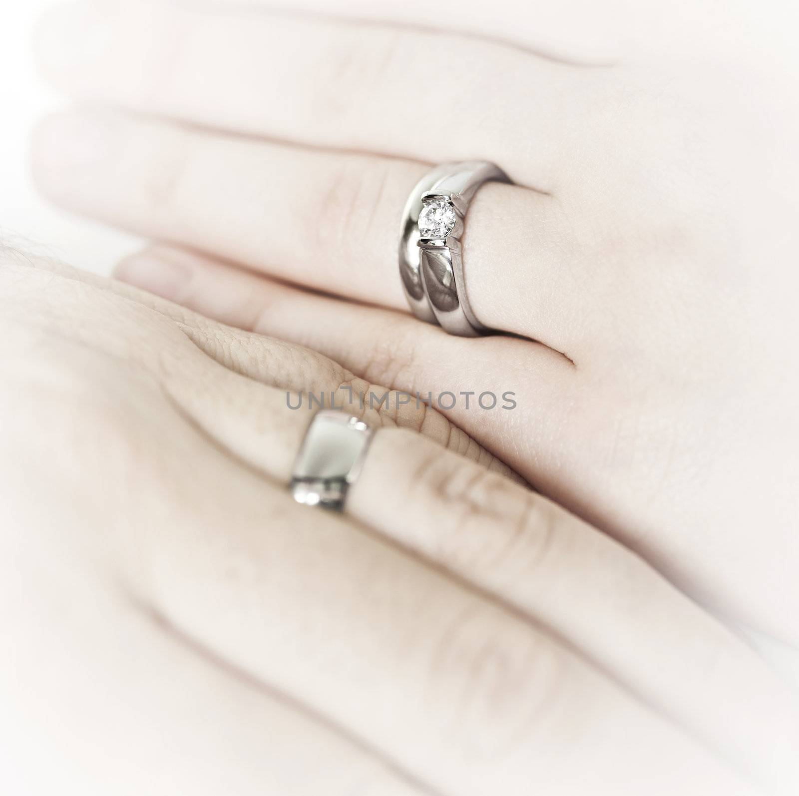 Hands wearing wedding rings by elenathewise