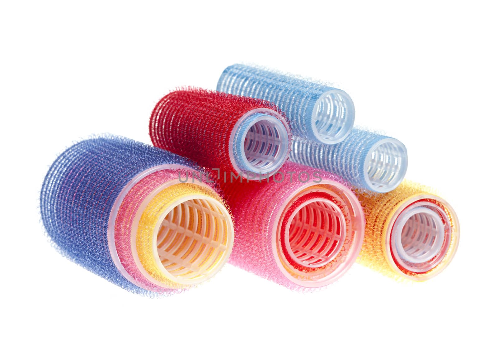 Colorful hair rollers stacked  isolated on white background