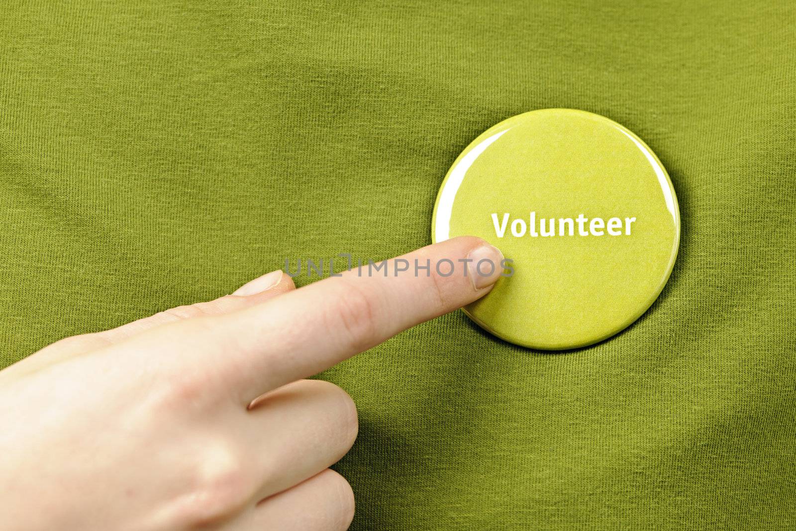 Finger pointing to green round volunteer button