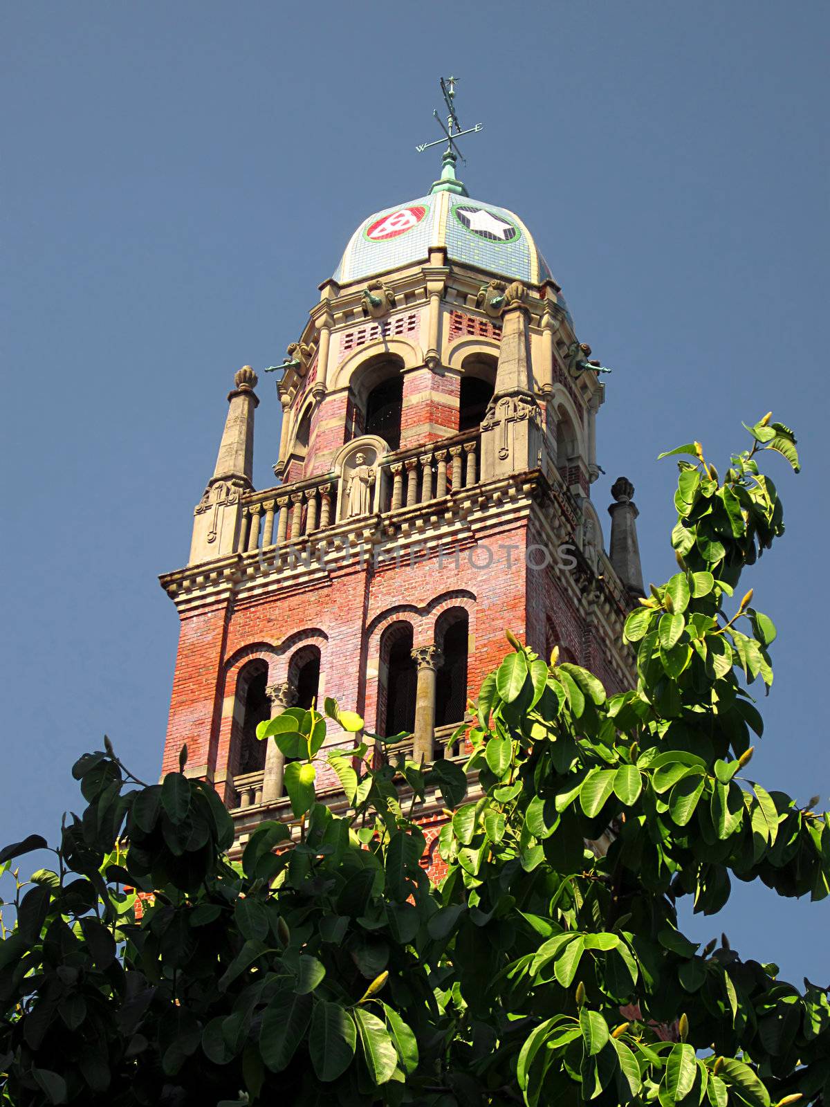 A photograph of a church bell tower detailing its unique architectural design.