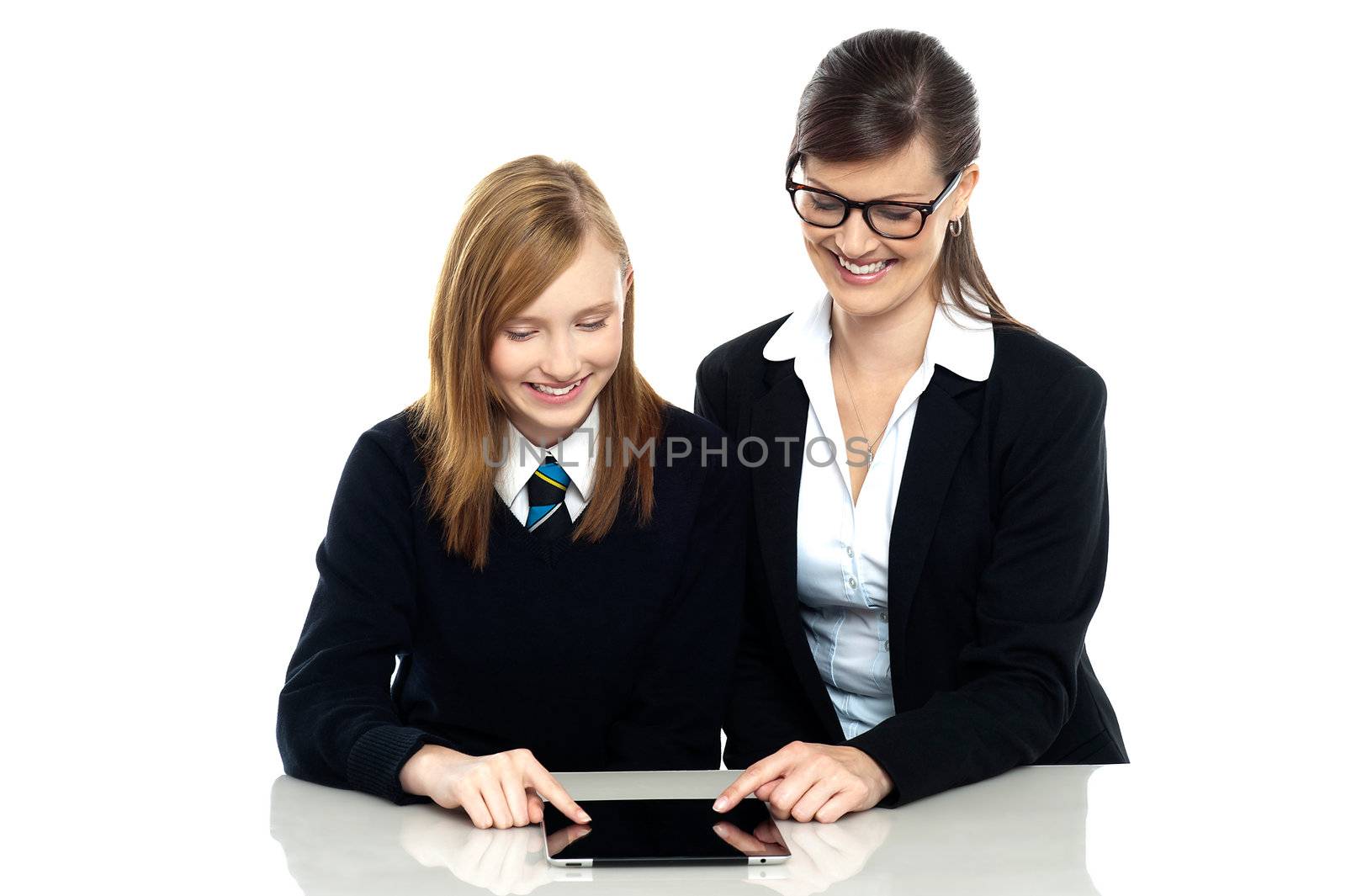 Stylish educator and pretty student exploring a tablet device. Isolated against white background.