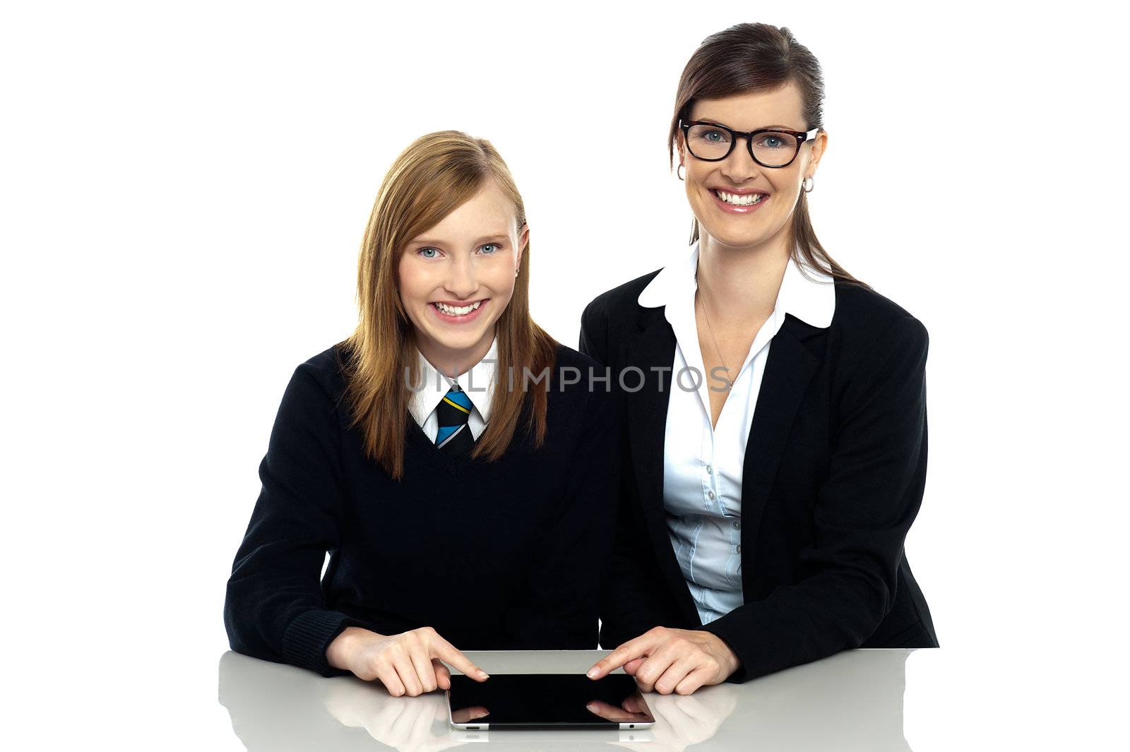 Tutor and student duo operating tablet pc by stockyimages