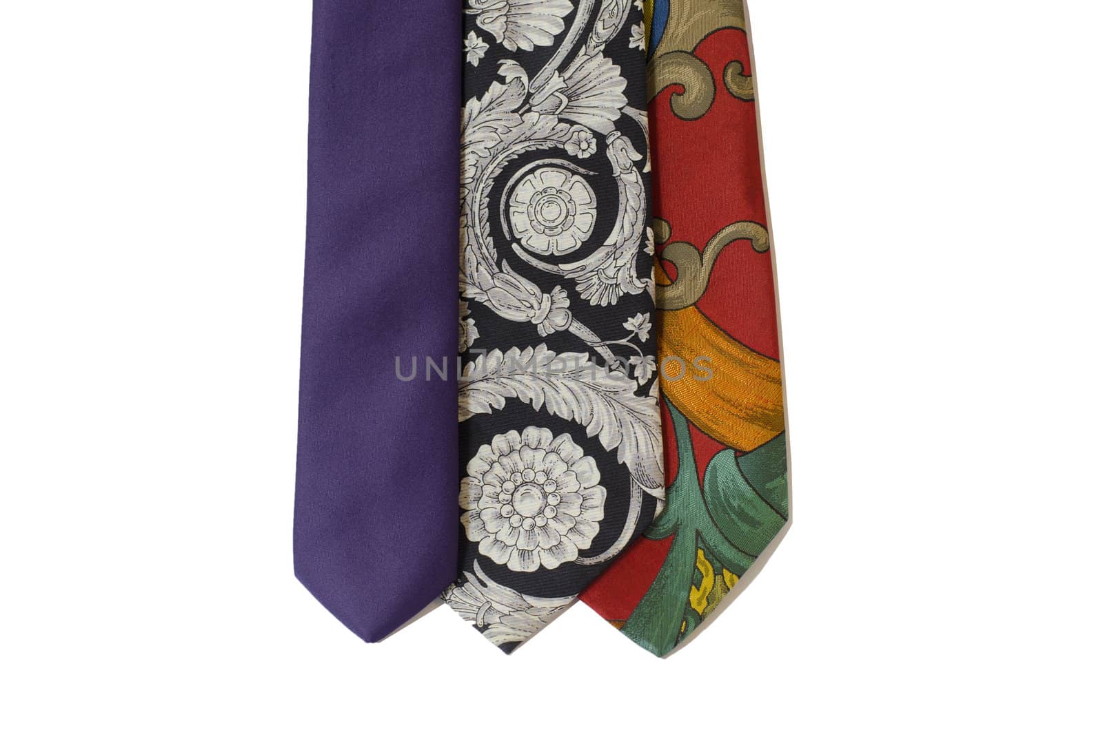 three neckties in different colors hanging isolated on white