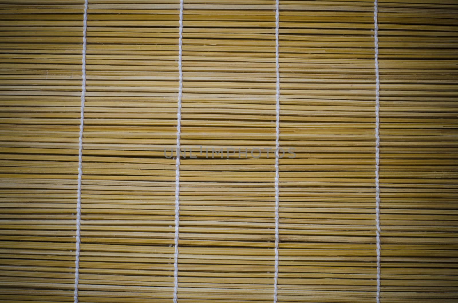 aged straws tied together with white thread textured background