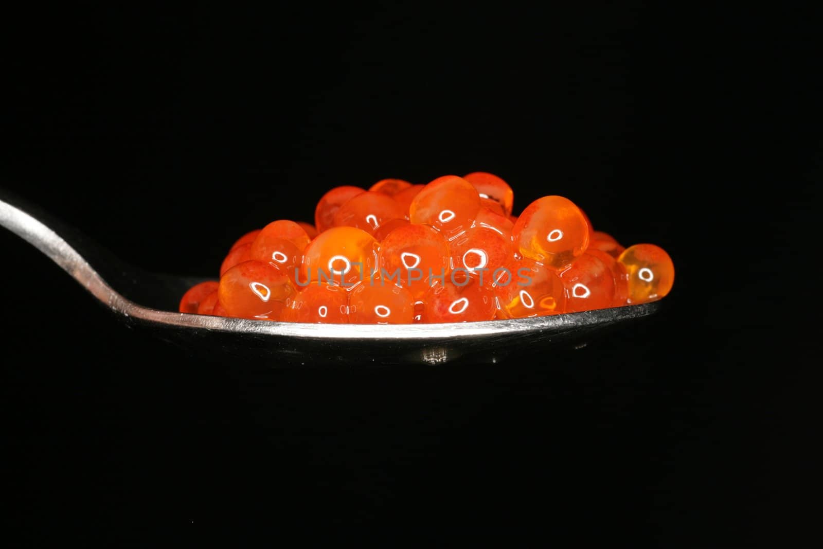 fresh orange caviar on a spoon fresh orange caviar on a spoon