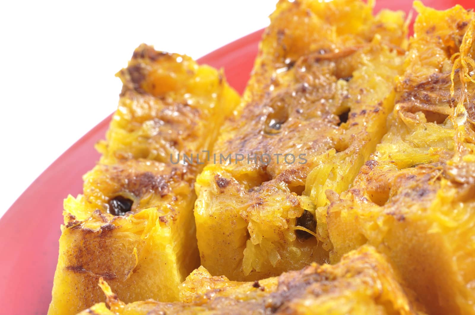 Closeup of steamed pumpkin with cinnamon and raisin on white background